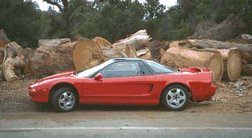 car on Arastadero, next to logs